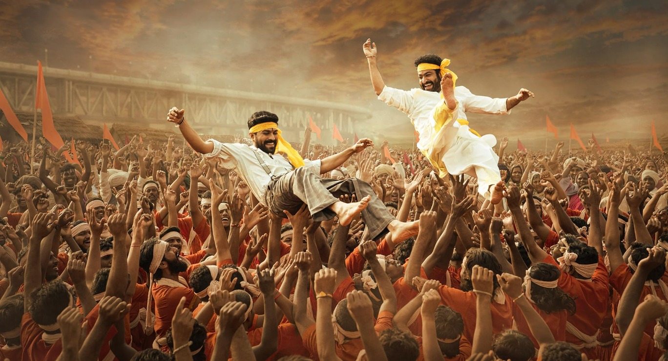 Official poster of RRR featuring Ram Charan and Jr. NTR in a high-intensity action pose symbolizing rebellion and patriotism.