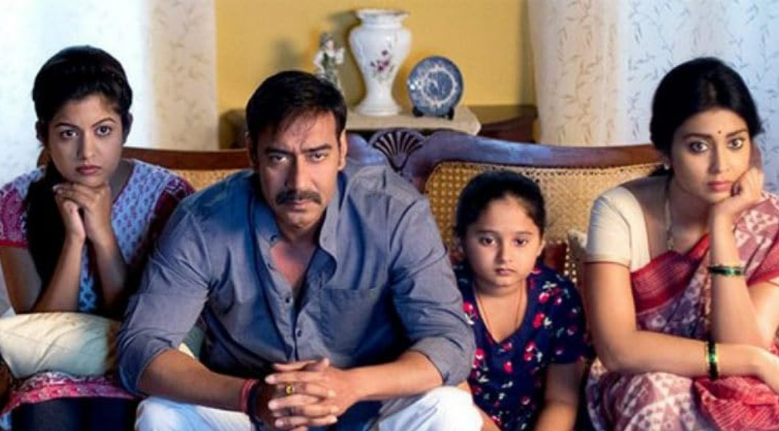 A suspenseful scene from Drishyam featuring a calm yet determined man entangled in a high-stakes investigation, capturing the film’s tense, mysterious, and gripping thriller atmosphere.
