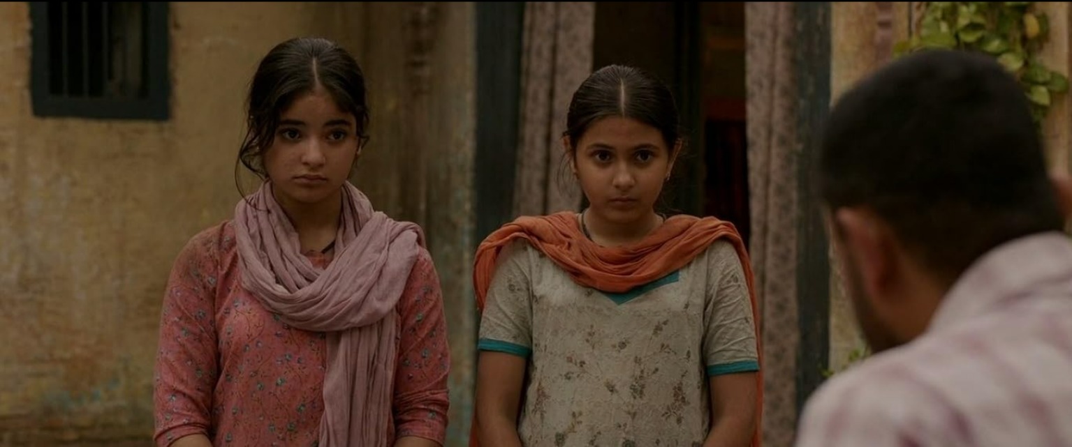 An intense moment from Dangal showing a determined wrestling training or match scene, highlighting themes of discipline, resilience, and the pursuit of excellence in the face of challenges. Bollywood films based on true stories