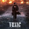 Yash strides through a rain-soaked, fire-lit street in the intense poster of Toxic, showcasing a dark, high-stakes action mood. Yash Toxic Release Date